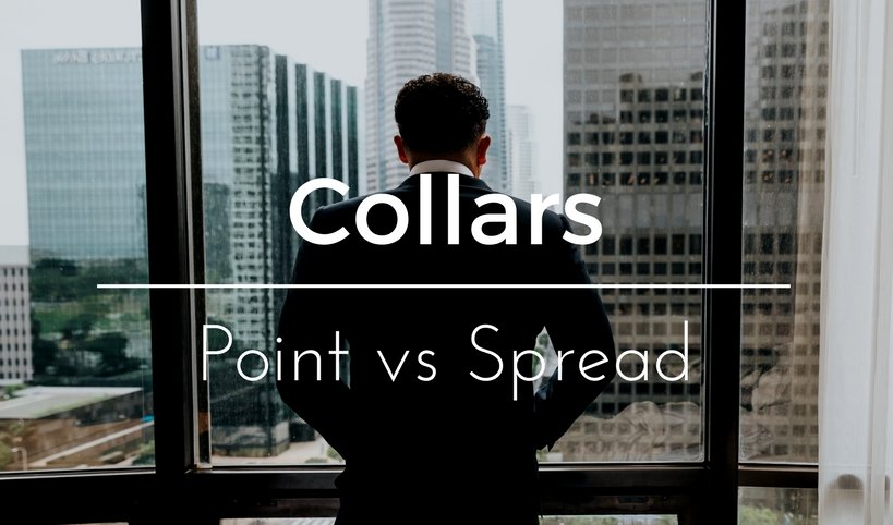 Spread vs Point Collar Man looking out of his hotel room wearing a suit